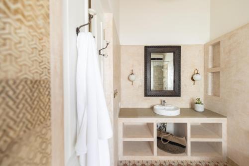 a bathroom with a sink and a mirror at LohonoStays Colina Villa E in Vagator