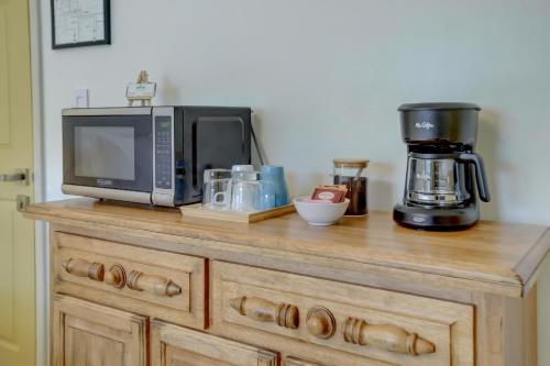 a microwave sitting on top of a wooden counter at LoKal Rental Tropical Florida destination in Fort Lauderdale