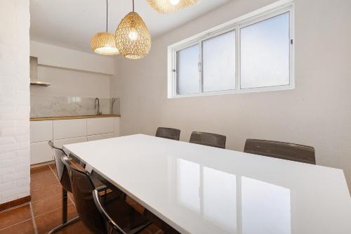 a meeting room with a white table and chairs at Soltroia Beach Court -Heated Pool in Troia