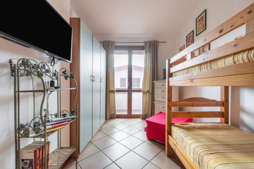 a bedroom with two bunk beds and a tv at Maya in Villasimius