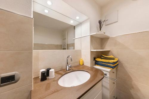 a bathroom with a sink and a mirror at Apartment Bergkristall in Nova Levante