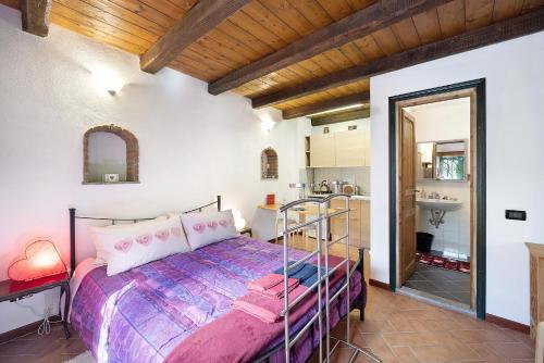 a bedroom with a bed and a bathroom with a sink at Ca' Kira in Molini di Triora