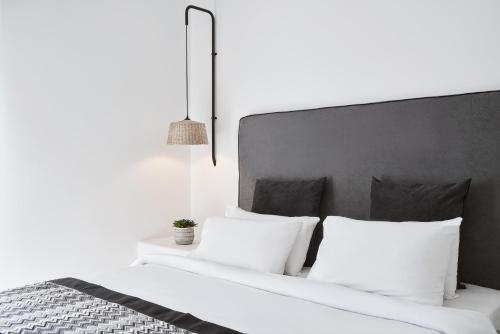 two beds with white pillows in a bedroom at Mr & Mrs White Mykonos in Platis Yialos Mykonos