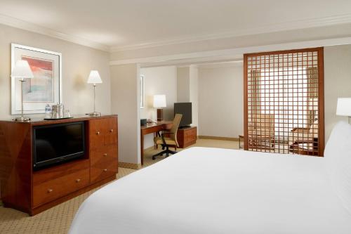 a hotel room with a bed and a television at San Diego Marriott Gaslamp Quarter in San Diego
