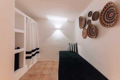 a room with a couch and a light on the wall at Mr & Mrs White Mykonos in Platis Yialos Mykonos