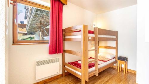 a bunk bed in a small room with a window at V du Bachat A04 ASTERS - Appt spacieux 4 pers in Chamrousse