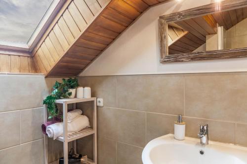 ein Bad mit einem Waschbecken und einem Spiegel in der Unterkunft Ferienwohnung Reschberg in Farchant