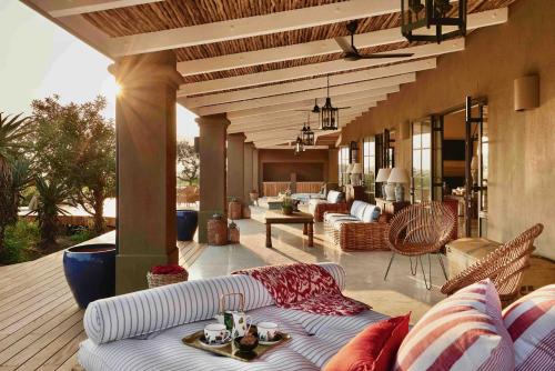 a living room with a couch on a patio at Royal Malewane in Thornybush Game Reserve