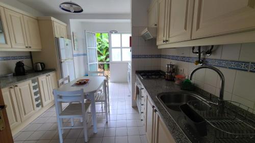 a kitchen with a sink and a counter top at The Best Atlantic Ocean View in Câmara de Lobos