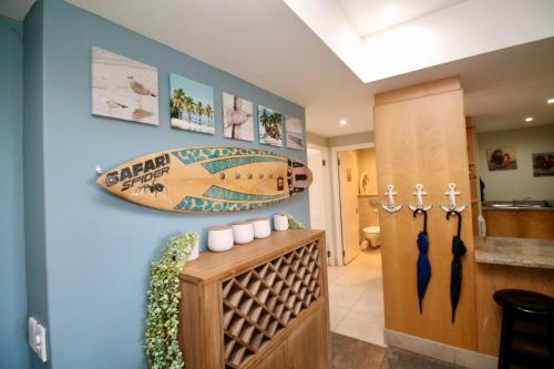 a home hallway with a surfboard on the wall at Mystique 17 in Shelly Beach