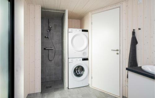 a bathroom with a washing machine and a shower at Nice Home In Hadsund With Kitchen in Hadsund