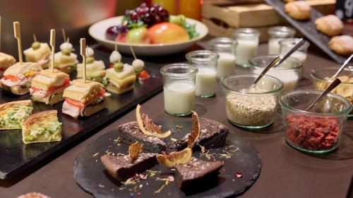 a table with a bunch of sandwiches and other foods at Novotel Zurich City West in Zürich