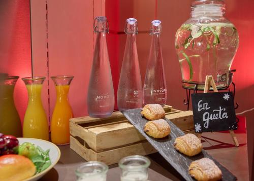 a table with soda bottles and a plate of food at Novotel Zurich City West in Zürich