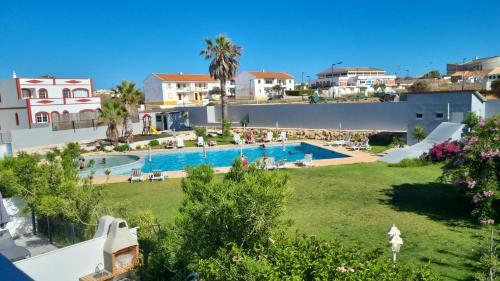 a view of a swimming pool in a resort at ENJOY POOL, BEACH and more at this nice 2bedroom apartment only 3 minutes from Mareta's Beach in Sagres