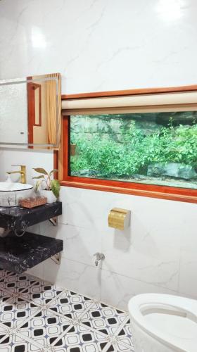 a bathroom with a toilet and a sink at Hang Mua Eco Garden in Xuân Sơn