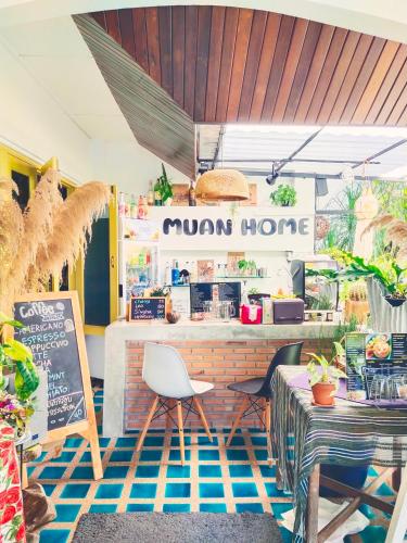 a restaurant with a monkey home sign on the wall at ม่วนโฮม muan home café&stay in Ban Don