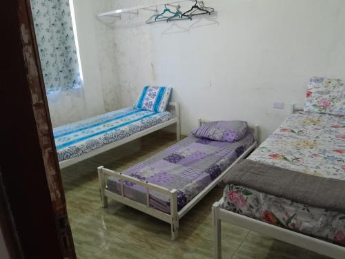 a room with two beds and a chair in it at Apartamento Anchieta 7 Belo in Rio de Janeiro