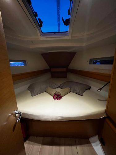 a bed in the middle of a room with a window at Dubrovnik Luxury Sailing in Dubrovnik