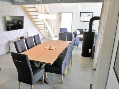 a dining room with a wooden table and chairs at Holiday Home Schwan by Interhome in Granzow