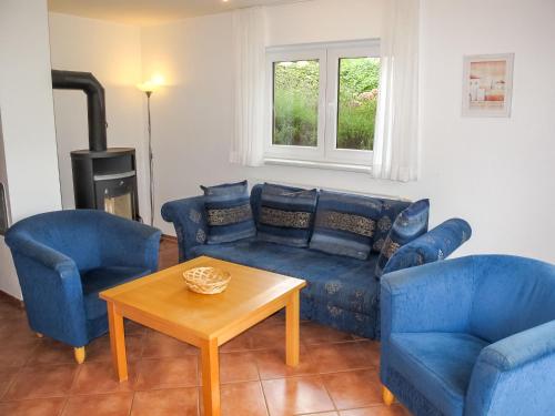 a living room with a couch and two chairs and a table at Holiday Home Müritz Ferienpark Röbel-22 by Interhome in Röbel