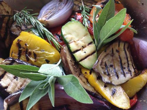 a plate of food with meat and vegetables with leaves at Charmantes Landhaus mit Garten und traumhaftem Fernblick in Thal