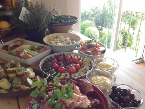 a table with many different types of food on it at Charmantes Landhaus mit Garten und traumhaftem Fernblick in Thal