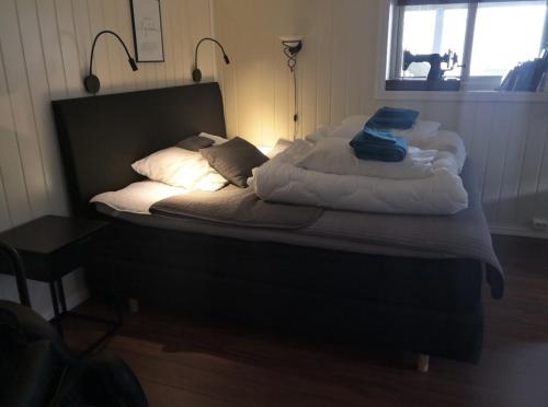 een ongemaakt bed in een kamer met een raam bij Sentral studioleilighet ved stranden og hvalsenter NB Må vaskes etter endt leie eller betale rengjøringshjelpen 500 kr in Andenes