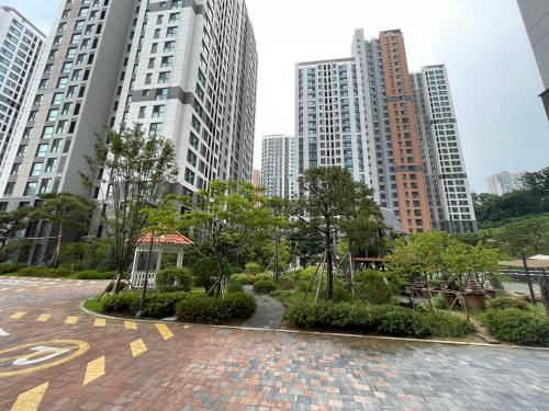 a park in the middle of a city with tall buildings at Omar's korean Guest house in Anyang