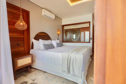 Ein Bett oder Betten in einem Zimmer der Unterkunft Carlore Hotel Taíba