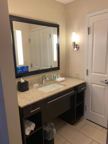 a bathroom with a sink and a large mirror at Homewood Suites by Hilton Munster in Munster