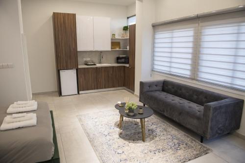 a living room with a couch and a table at STAY Glam Skin Studio in Nicosia