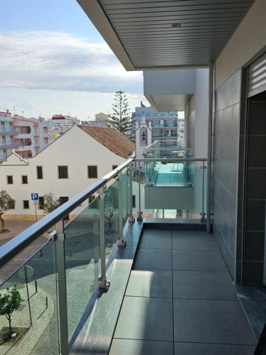 an open balcony with a view of a building at Apartment Dona Vitória - Monte Gordo Beach in Monte Gordo