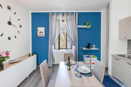 a dining room with blue walls and a table and chairs at RHOme 8 - 4 minutes from Rho Fiera in Rho
