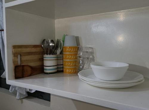 a shelf with a plate and a bowl on it at CityLofts Plainview in Mandaluyong corner unit in Manila