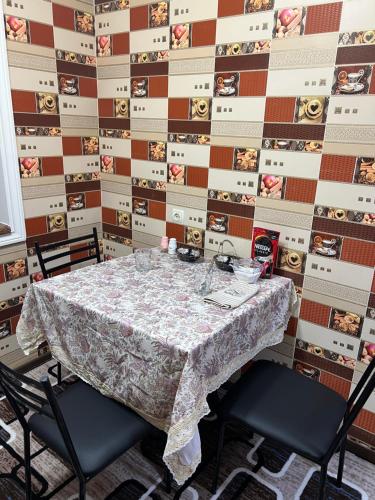 a dining room with a table and two chairs at Khujand comfort in Khujand