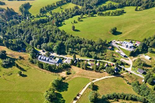 an aerial view of a house in a field at Horský Hotel Sněženka in Hynčice pod Sušinou