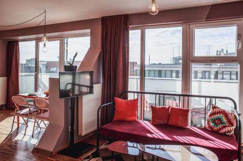 a room with a bed and a balcony with a table at The Circus Hostel in Berlin