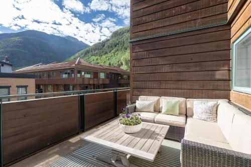 a patio with a couch and a table on a balcony at Ice House 317 condo in Telluride