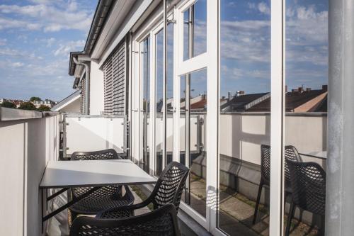 a balcony with chairs and a table and a window at The Circus Hostel in Berlin