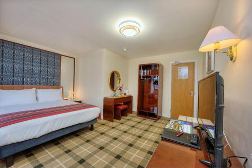 a hotel room with a bed and a bathroom at Muthu Fort William Hotel in Fort William