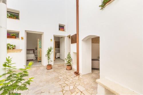 a hallway of a house with potted plants at Dimora Ferente in Salve