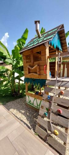 a wooden play house with a chain around it at Dr Becsey Luxury Apartman in Békéscsaba