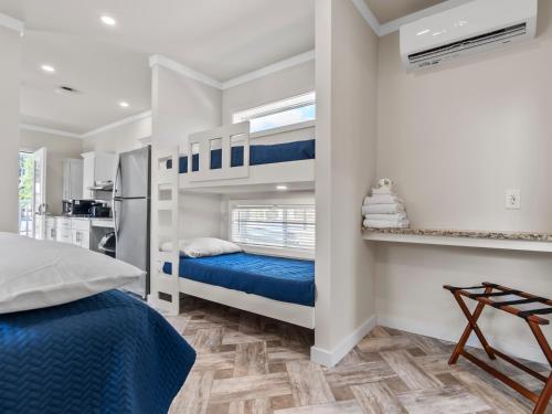 a bedroom with two bunk beds and a kitchen at Shore Point Cottages in Ocean City