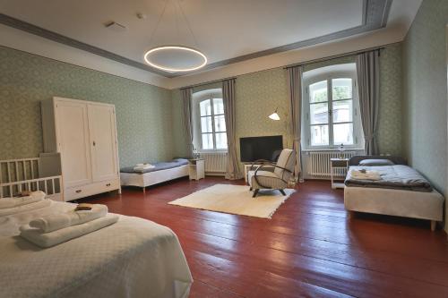 a large room with two beds and a television at Just Jimramov in Jimramov