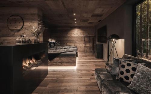 a living room with a couch and a fireplace at Luxury Chalet Vilaiet in Ortisei