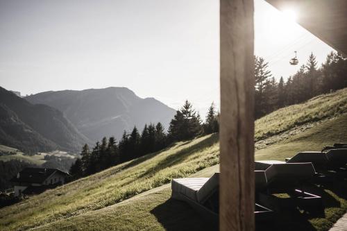 a room with a chair on a hill with a ski lift at Luxury Chalet Vilaiet in Ortisei