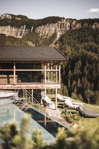 a resort with a pool and a water slide at Luxury Chalet Vilaiet in Ortisei