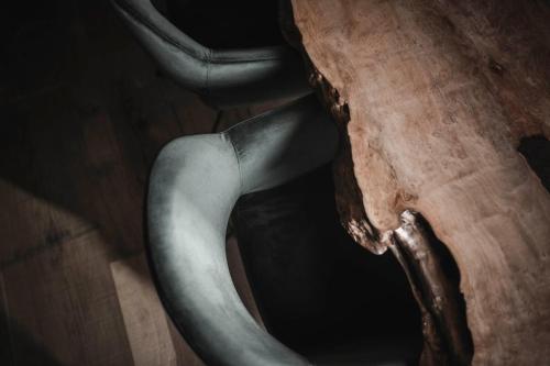 a trunk of a tree with a piece of wood at Luxury Chalet Vilaiet in Ortisei