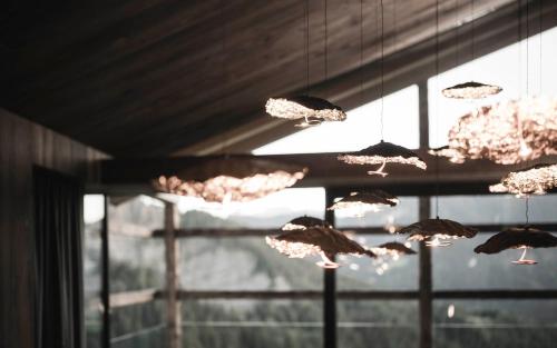 a bunch of butterflies hanging from a ceiling at Luxury Chalet Vilaiet in Ortisei