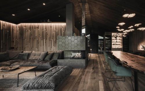 a living room with a couch and a table at Luxury Chalet Vilaiet in Ortisei
